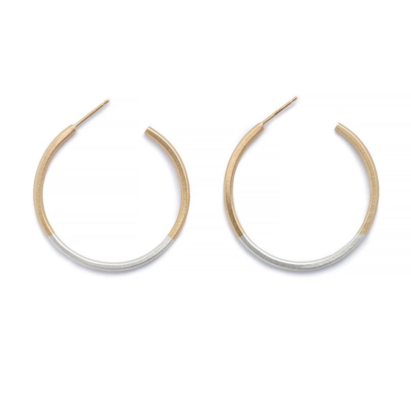 Minimalist, lightweight, mixed metal hoops of 14k yellow gold and sterling silver hand-forged wire, with 14k gold earring posts. Size small, one and one-eighth inches in diameter. Hand-crafted in Portland, Oregon.