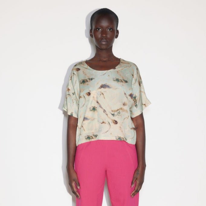 A loose fitting top with a boat neck in a blue, green and brown swirling design. Designed and made by Eve Gravel in Montreal, Canada.