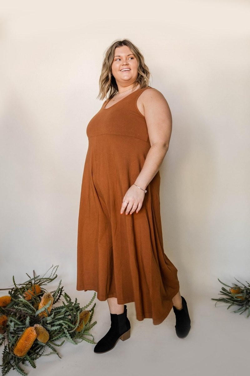 Relaxed sleeveless midi-length jumpsuit with pockets in the color Saddle Brown. The Lakeside Jumpsuit is designed by Mien and made in Los Angeles, CA.