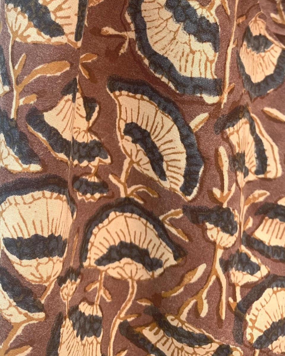 Closeup of the Oversized Scarf in Lena. The scarf is brown with a cream and dark grey floral pattern printed on top.