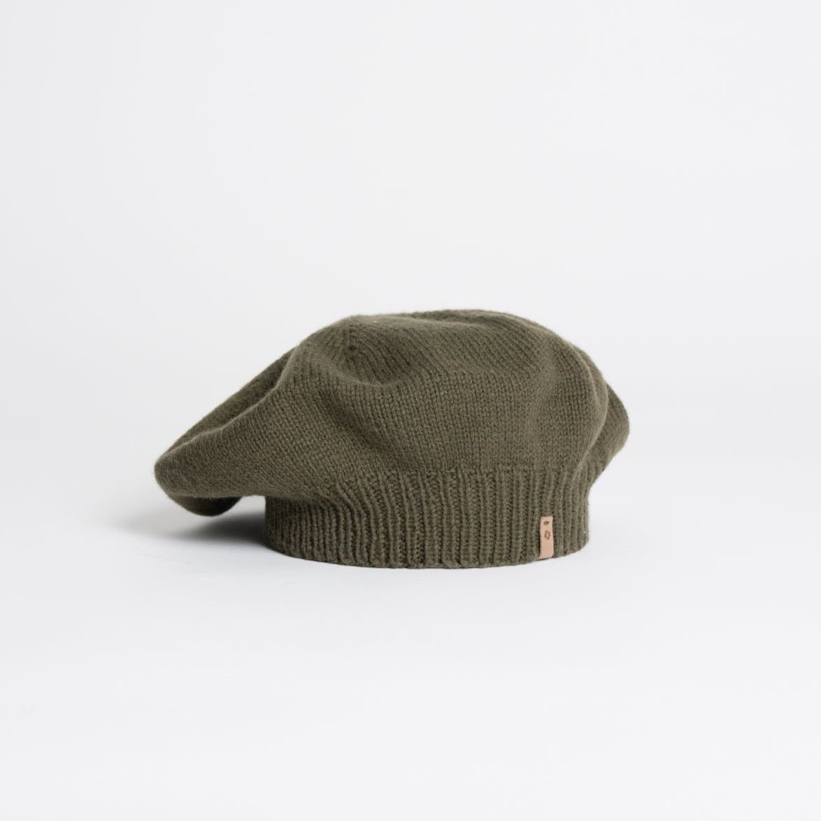A slouch style hat with fitted ribbed collar. The Merino Beret in Olive Green is designed by Dinadi and hand knitted in Kathmandu, Nepal.