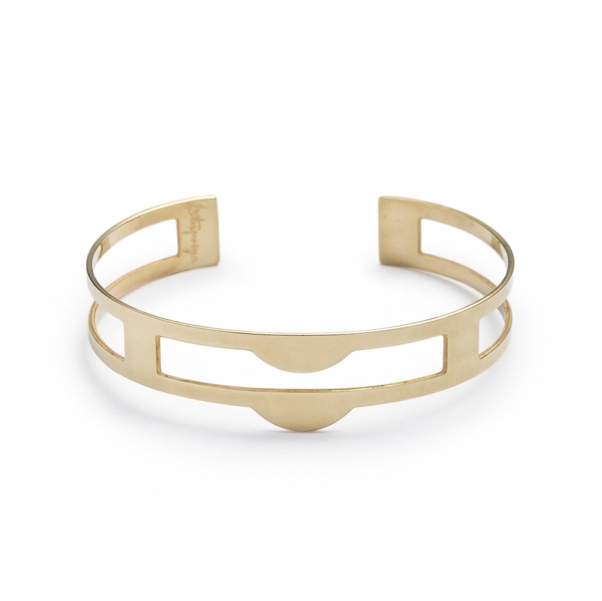 Edgy, lightweight, and adjustable cuff bracelet of polished brass, with three rectangular cutouts through the center of the cuff and two semicircle-shaped peaks at the front of the cuff. Hand-crafted in Portland, Oregon.
