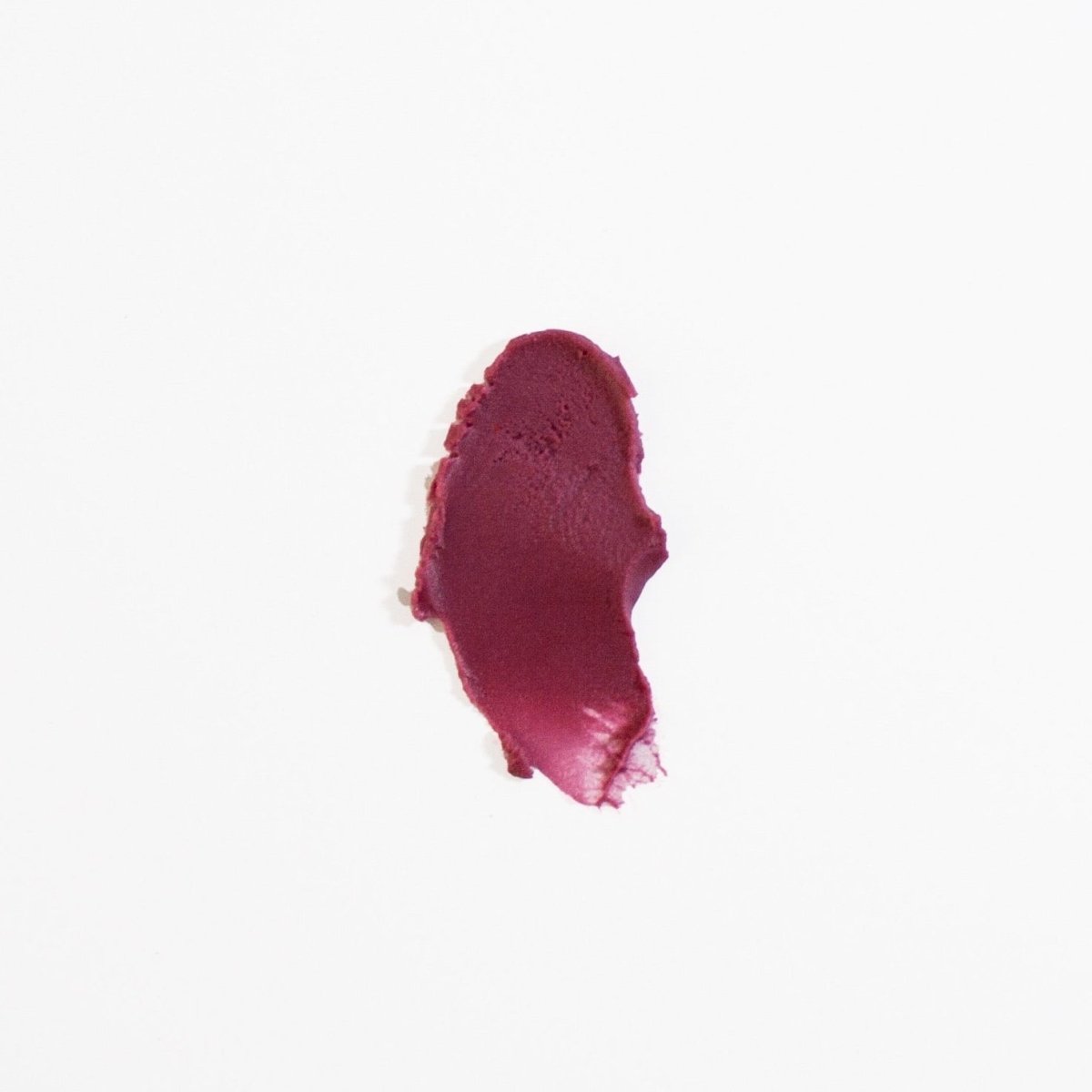 A magenta colored swatch of lip tint against a white background. The Lip Tint & Conditioner in Melrose is crafted by Aenons and made in Los Angeles, CA.