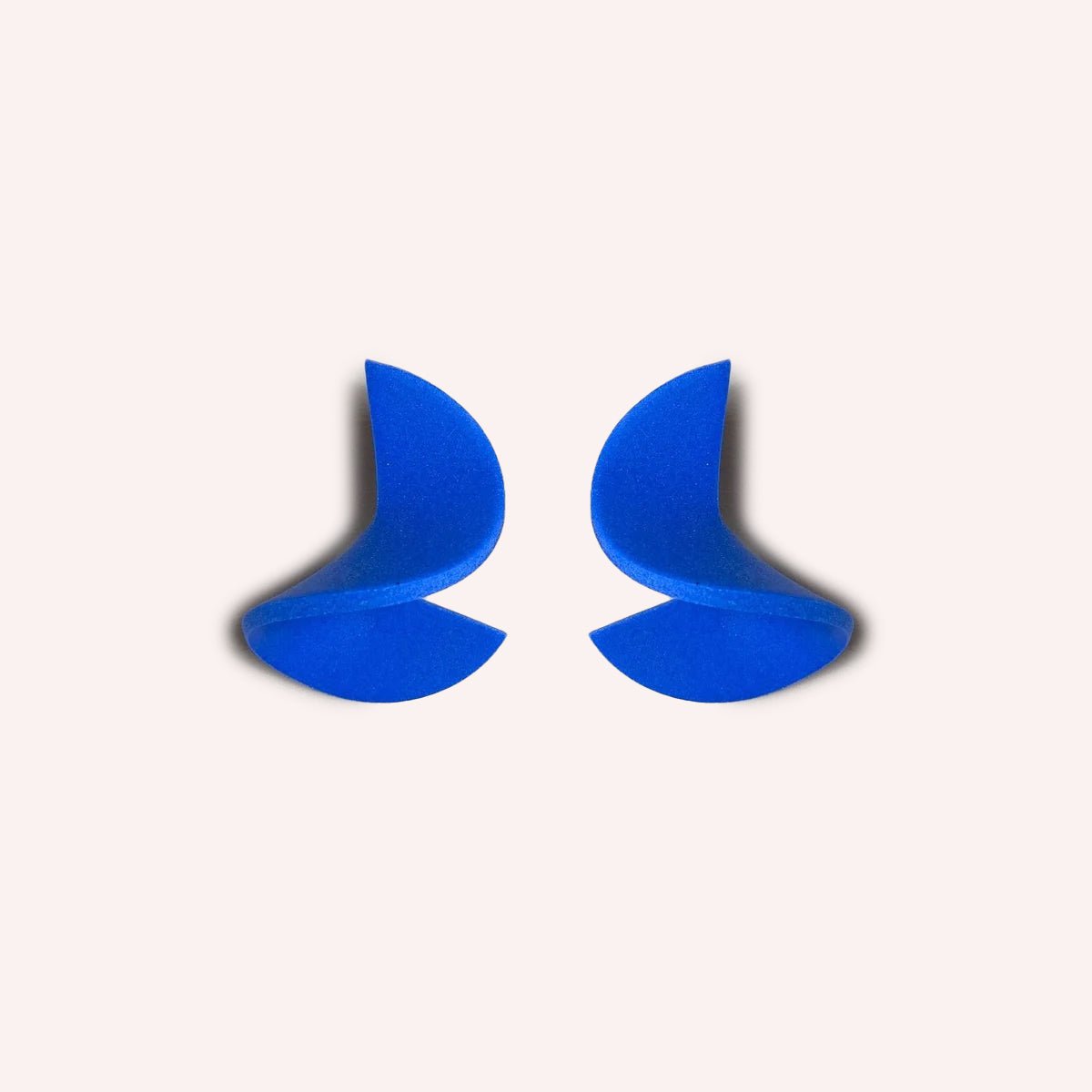 A polymer clay stud earring folded into a small wave. The Modern Crinkle Earrings in Blue are designed and handcrafted by Little Pieces Jewelry in Los Angeles, California.