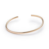 Classic, simple, and adjustable stacking cuff of hand-forged brass wire, with etched notch details on both ends of the cuff. Hand-crafted in Portland, Oregon.