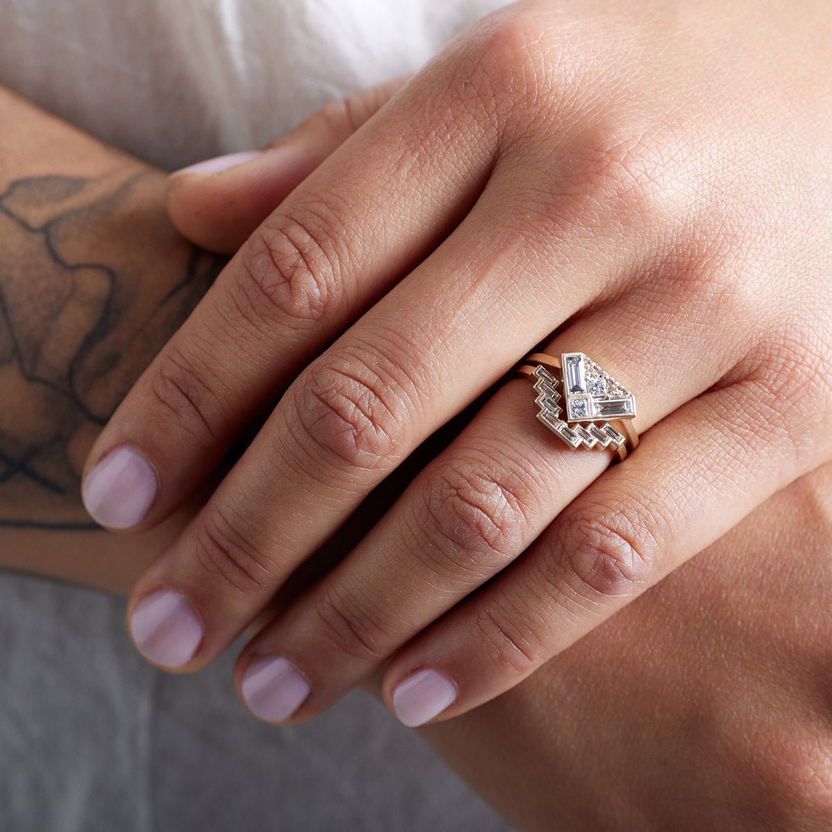 Model wears the Aurore ring stacked with the Montis ring.