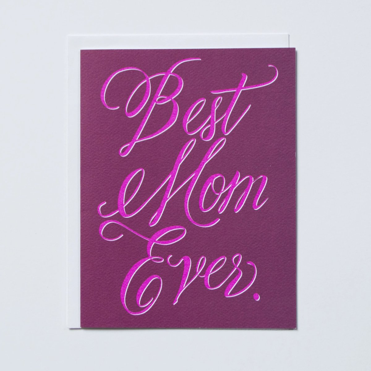 Greeting card reads "BEST MOM EVER" in fuchsia script against a purple background. Printed by Banquet Atelier in Vancouver, Canada.
