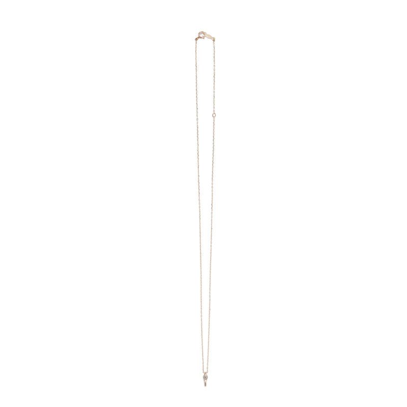 Tiny, ankh-shaped pendant of 14k yellow gold, topped with a round, bezel-set white diamond, and threaded with a delicate gold chain with spring-ring clasp. Hand-crafted in Portland, Oregon.