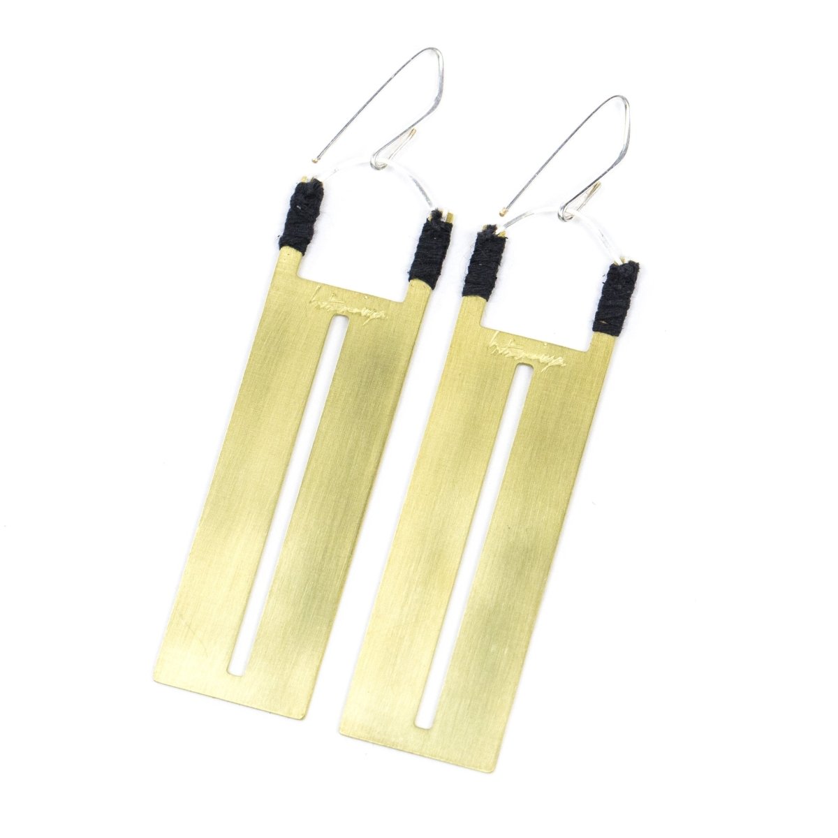 Rectangular brass pendants with thin slit cutouts down the center, accented with gray Japanese cotton thread and sterling silver earring wires, and engraved on the back with the betsy & iya logo. Hand-crafted in Portland, Oregon.