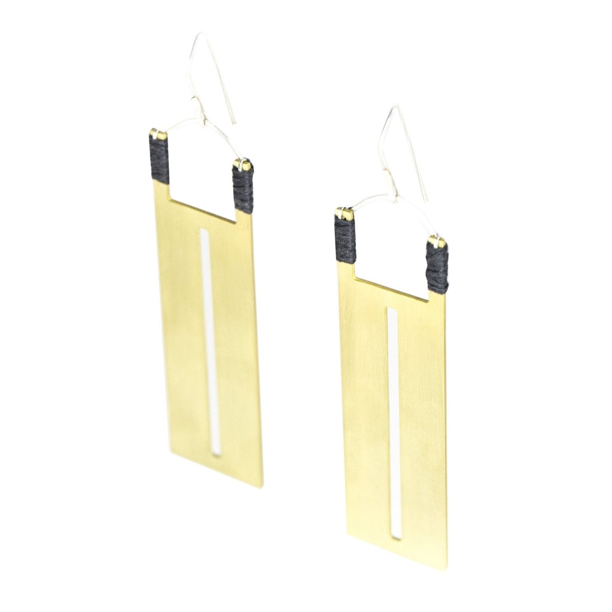 Rectangular brass pendants with thin slit cutouts down the center, accented with gray Japanese cotton thread and sterling silver earring wires. Hand-crafted in Portland, Oregon.