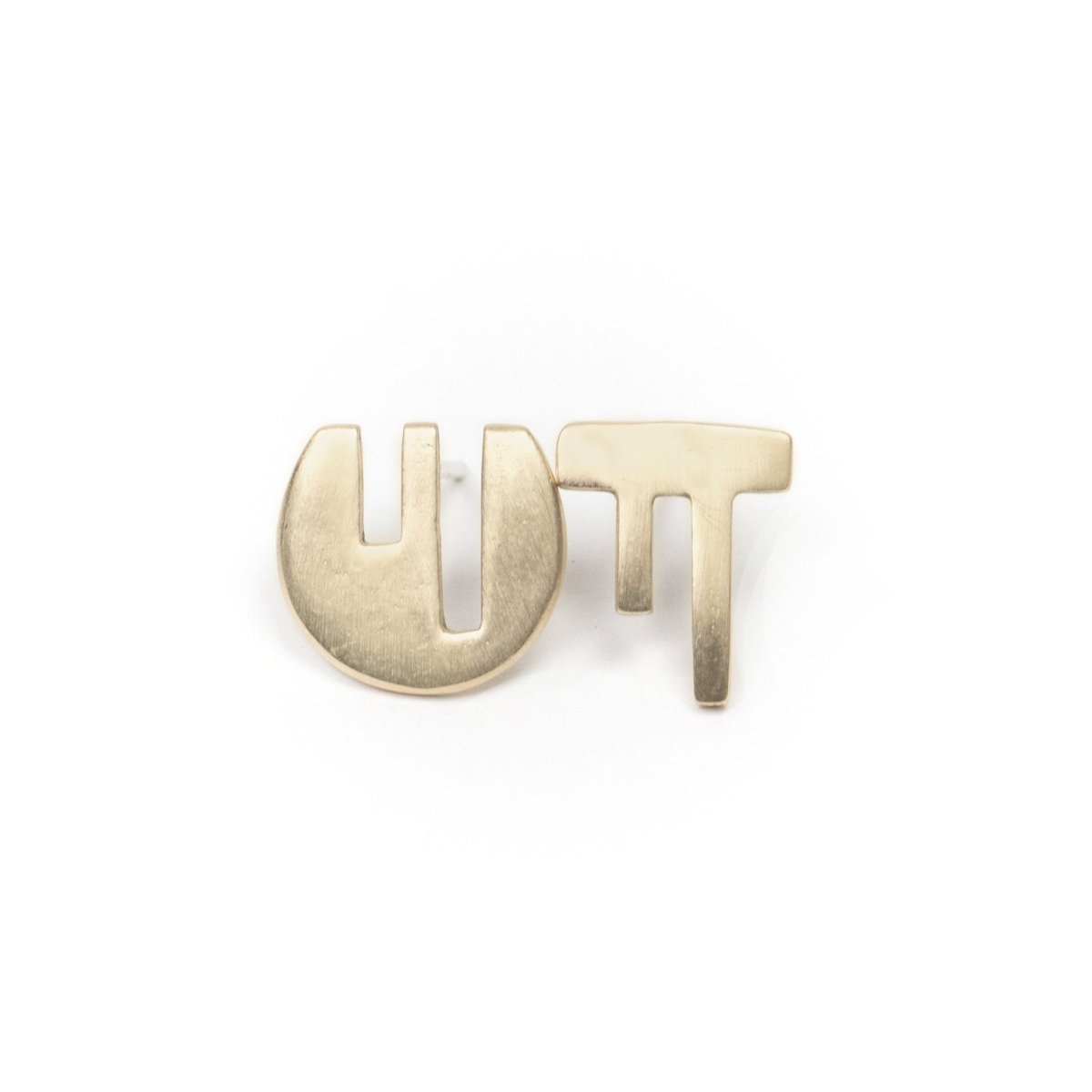 A pair of mismatched, 14k gold stud earrings, with complementary geometric cutouts that fit into one another like puzzle pieces. Hand-crafted in Portland, Oregon.