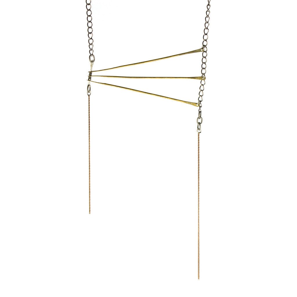 Long modern style grazing gilt necklace by betsy & iya.