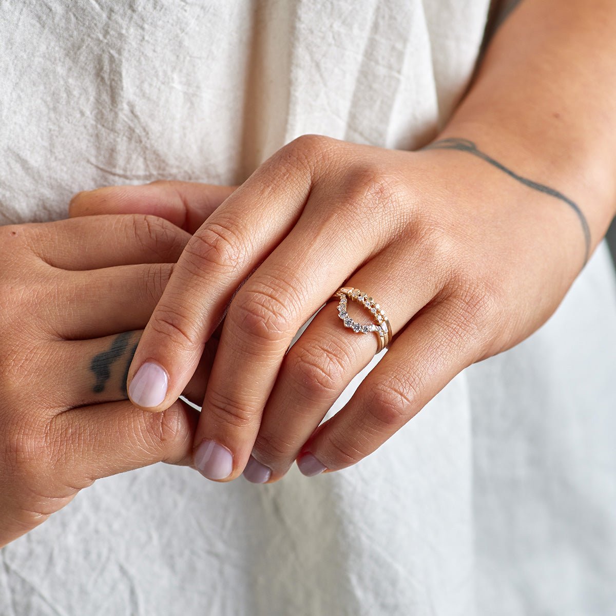 Model wears a stack of the Itero, Alma and Ortus rings (listed from top to bottom).