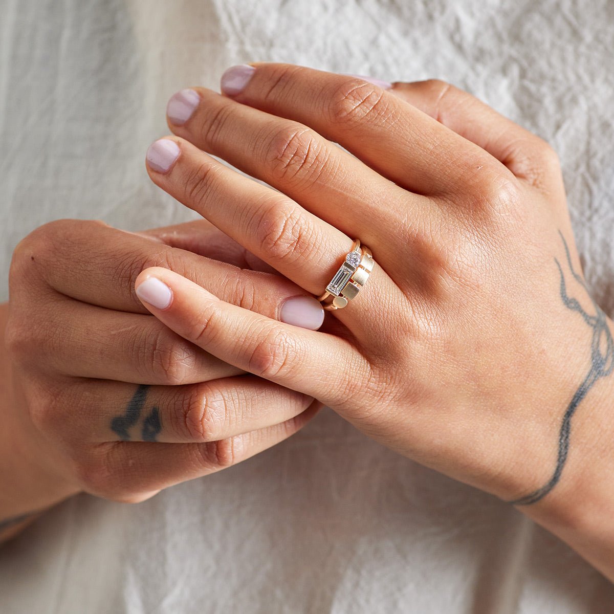 Model wears the Otium ring on top of the Figura ring.