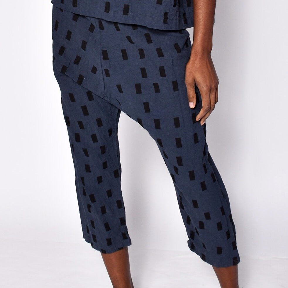 Loose fitting straight leg cropped navy blue pants with black square pattern. Designed and sewn by Uzi in Brooklyn, New York.