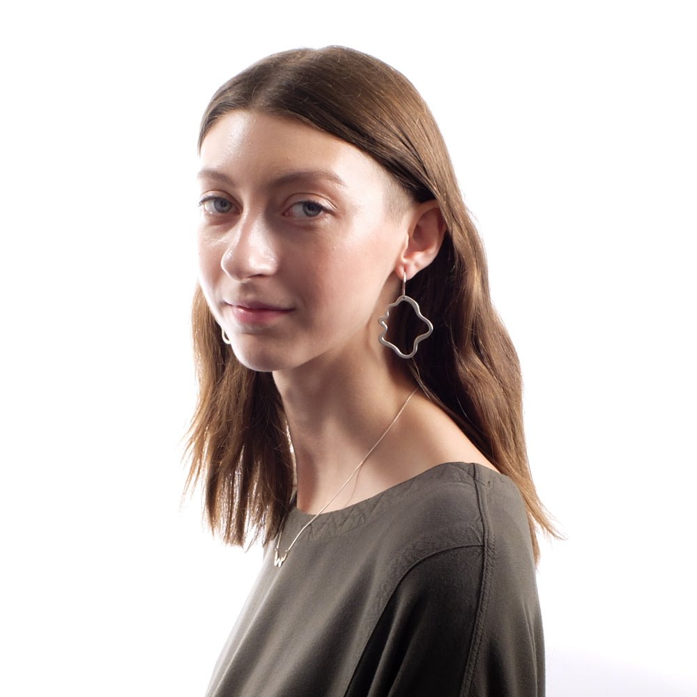 Sterling silver betsy & iya Semita earrings, styled on a model with the bronze betsy & iya Semita necklace and an olive top from Tienda Ho.