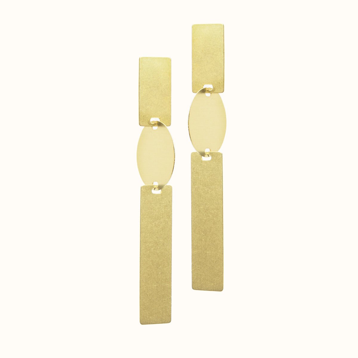 A long brass earring made with two rectangular pieces interconnected with a single circular shape. Designed and handcrafted in Portland, Oregon.