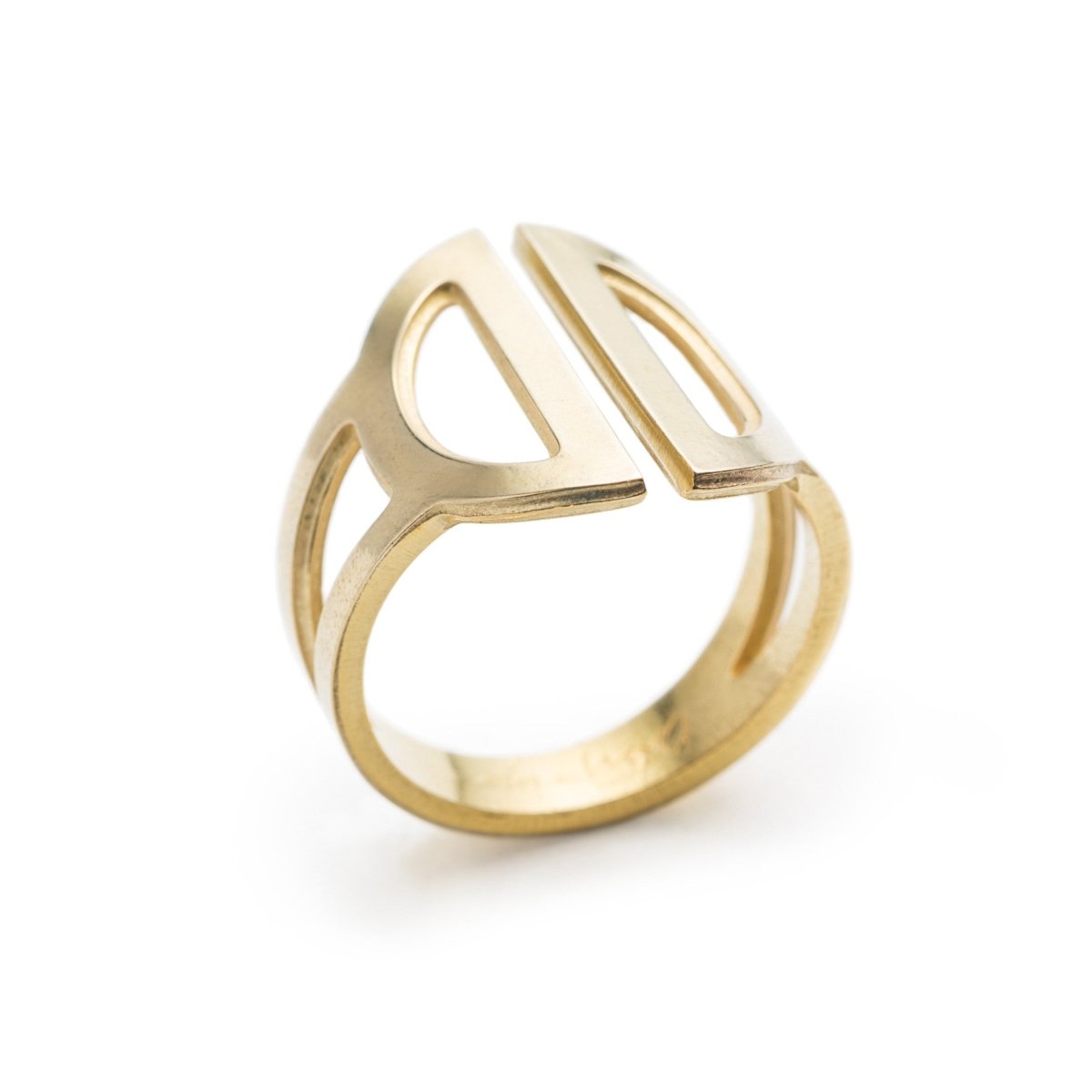 Wide, adjustable, polished brass ring, featuring two triangular cutouts on the band and a pair of semicircle cutouts as the focal point. Hand-crafted in Portland, Oregon.