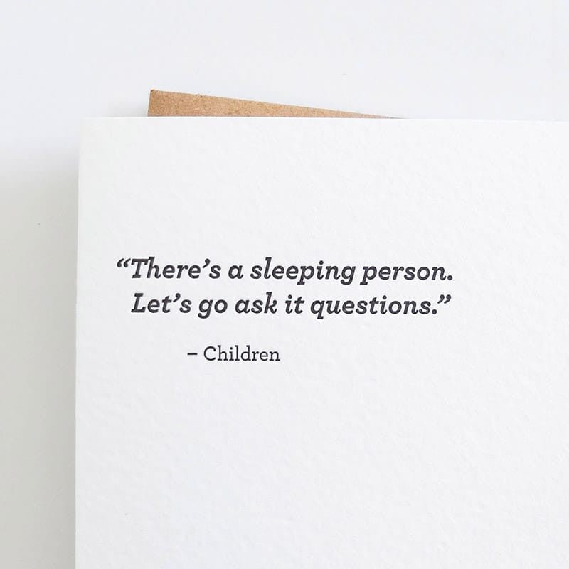 Kraft card with black text that reads: "THERE'S A SLEEPING PERSON. LET'S GO ASK IT QUESTIONS - CHILDREN." Comes with a brown Kraft envelope. Designed by Sapling Press and made in Pittsburgh, PA.