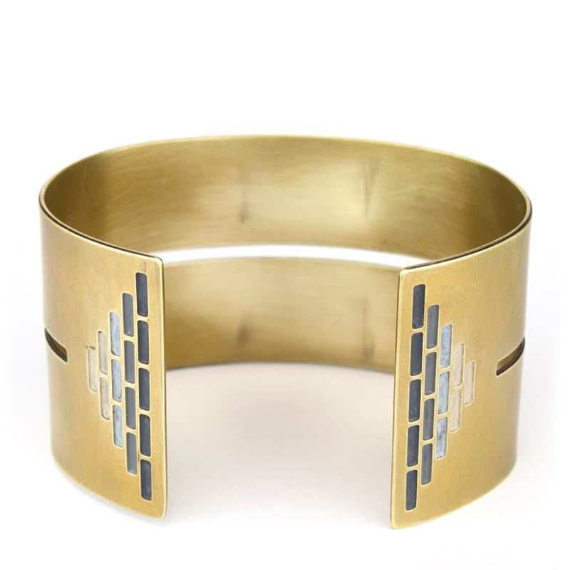 Wide, bold, brass cuff bracelet in the Portland colorway, with a cutout slit that runs through the center of the cuff and stops just short of a pyramid of grayscale paint on either end. Hand-crafted in Portland, Oregon.