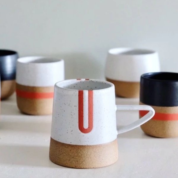 Handle mug with a white speckled and natural clay finish along with red detailing. The Tucker Mug with Red Detail is designed and handmade by Wolf Ceramics in Hood River, Oregon.