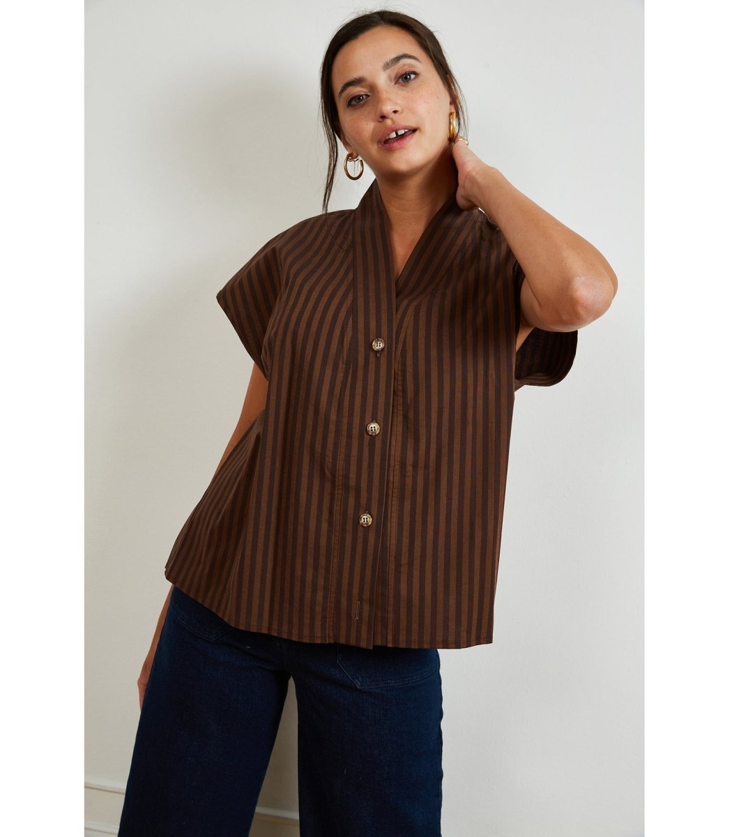 A short sleeve tunic button up in brown stripes. Model has shirt untucked. The Sienna Top in brown Stripe is designed by Loup and made in New York City.