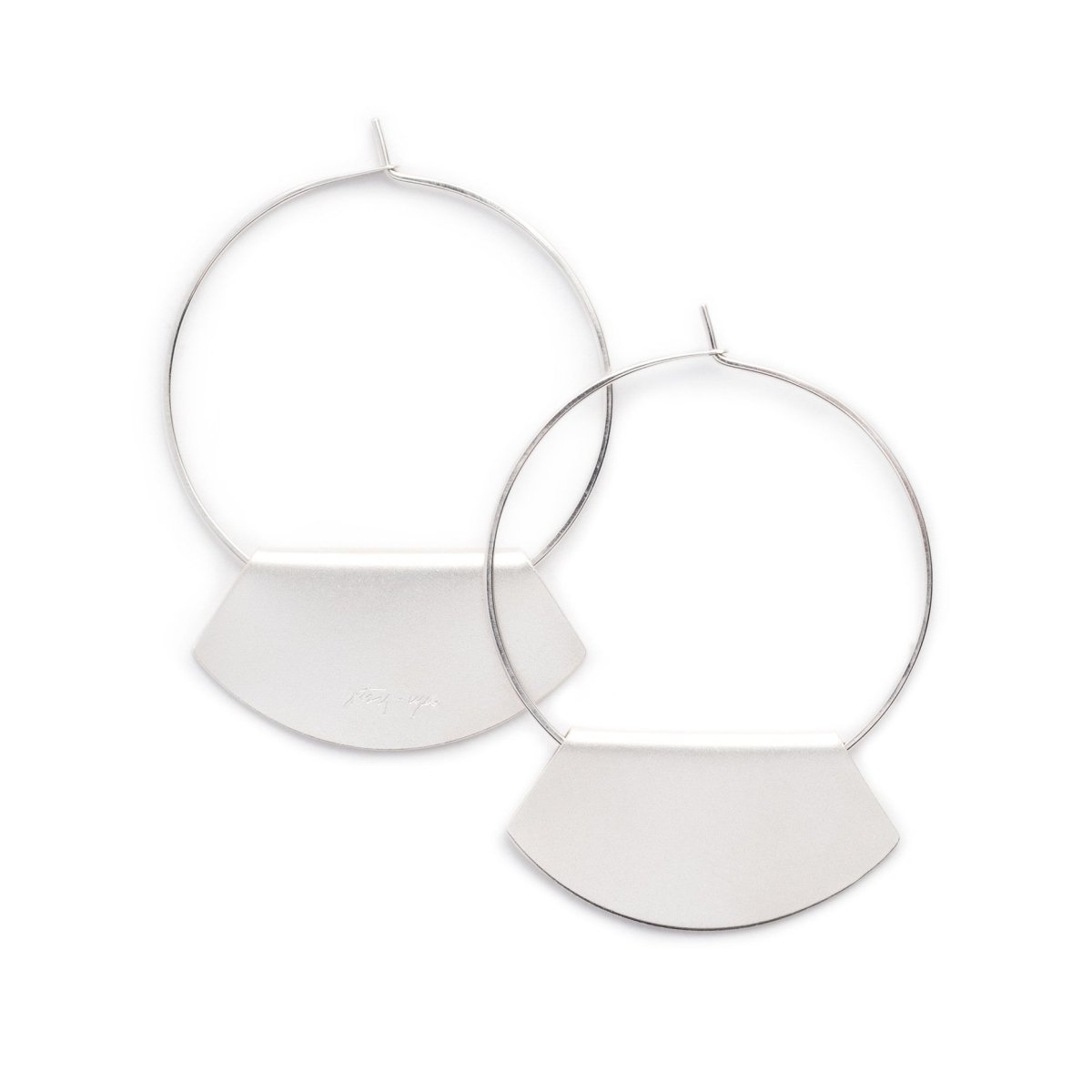 Hand-formed hoop earrings of sterling silver wire, with folded, fan-shaped, silver-plated pendants, engraved with the betsy & iya logo. Hand-crafted in Portland, Oregon.