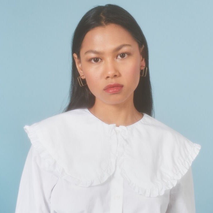 Square Caged Hoops in size small. Worn on a model with black hair. Designed and handcrafted baby Natalie Joy in Portland, Oregon.