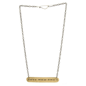 A long, full view of the betsy & iya morse code necklace.