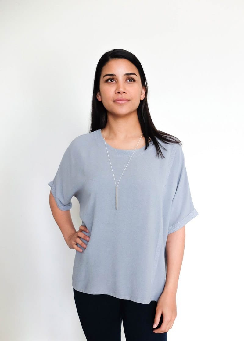 Model wears the 30" Olandia necklace with a Taznakte top from Tienda Ho. The Olandia has a bronze rectangular bar strung on a sterling silver chain.