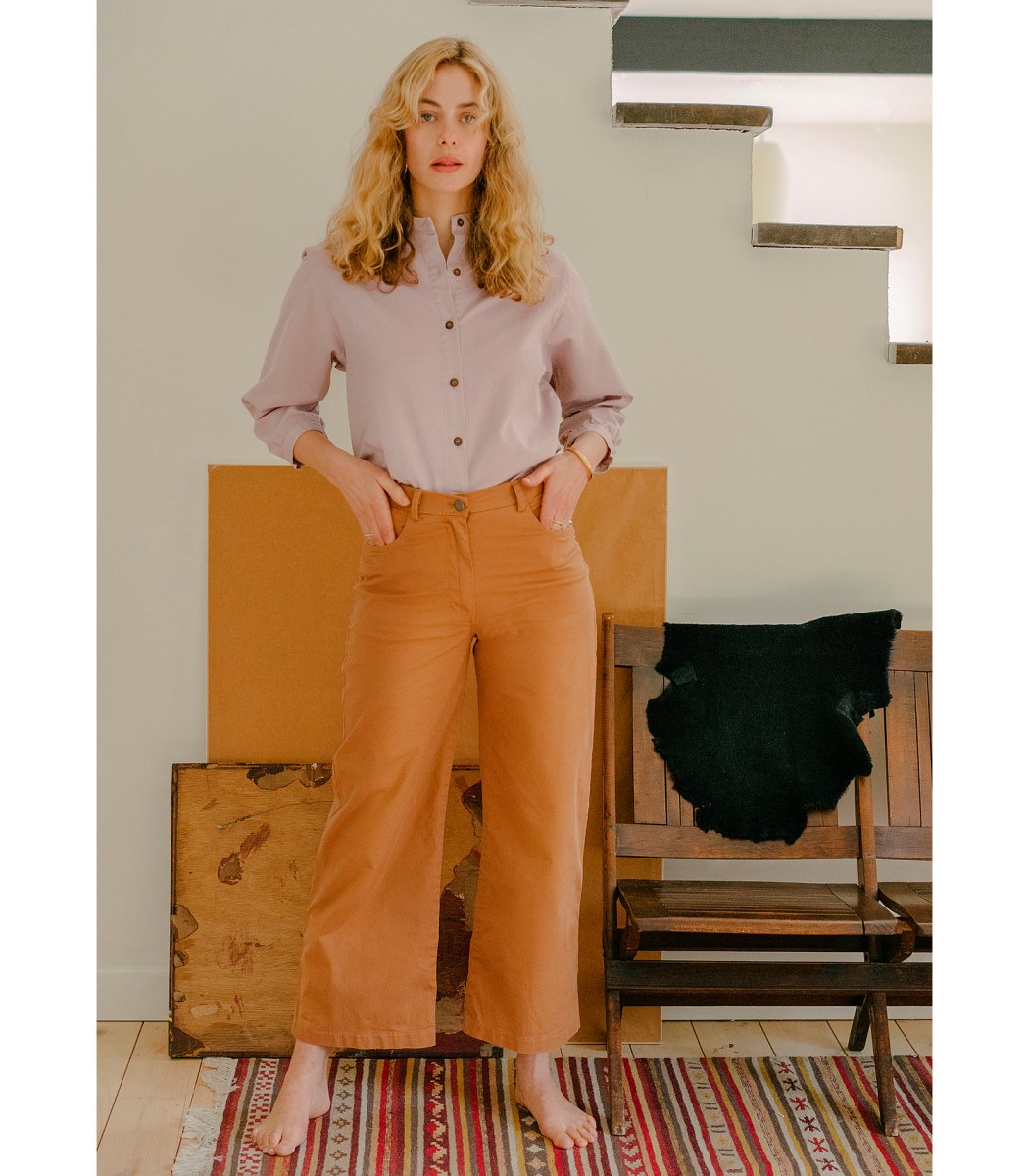 Model wears cropped wide leg jeans in Tan. The Toni Jeans in Tan are designed by Loup and made in New York City, USA.