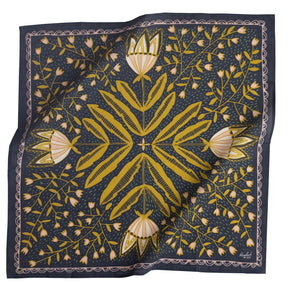 A dark blue bandana with a mirror image of a yellow, pink and white floral pattern. Designed by Hemlock Goods in Fulton, MO and screen printed by hand in India.