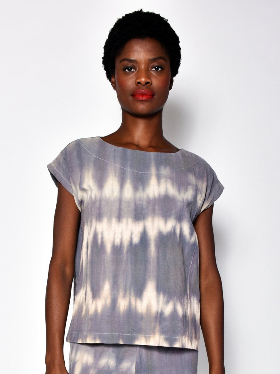 Short sleeve tunic with violet and white rippled tie dye effect. Designed and sewn by UZI in Brooklyn, New York.