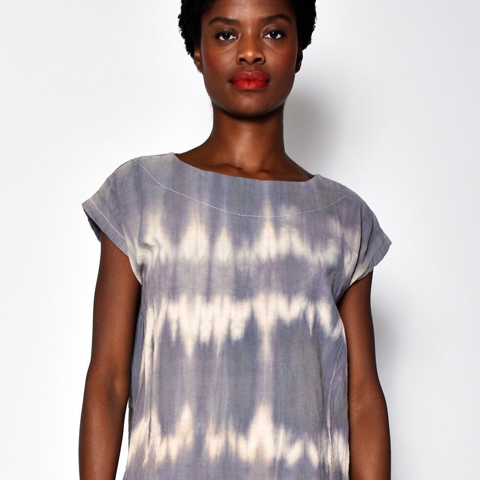Short sleeve tunic with violet and white rippled tie dye effect. Designed and sewn by UZI in Brooklyn, New York.
