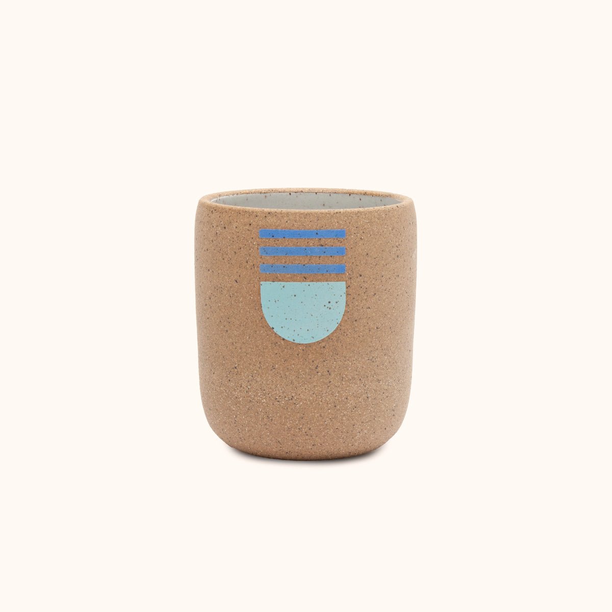 Speckled stoneware cup with painted blue half circle and triple line design. Designed and hand thrown by Wolf Ceramics in Hood River, Oregon.
