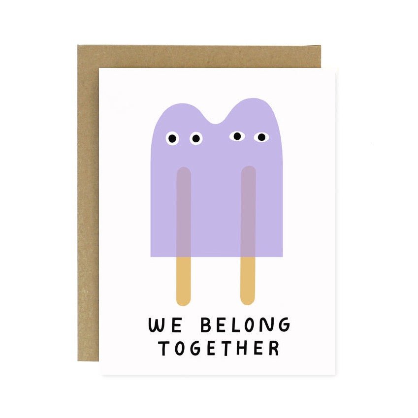 Front of card reads: "WE BELONG TOGETHER." A white greeting card with a purple double stick popsicle illustration. Designed and handcrafted by Worthwhile Paper in Ypsilanti, MI.