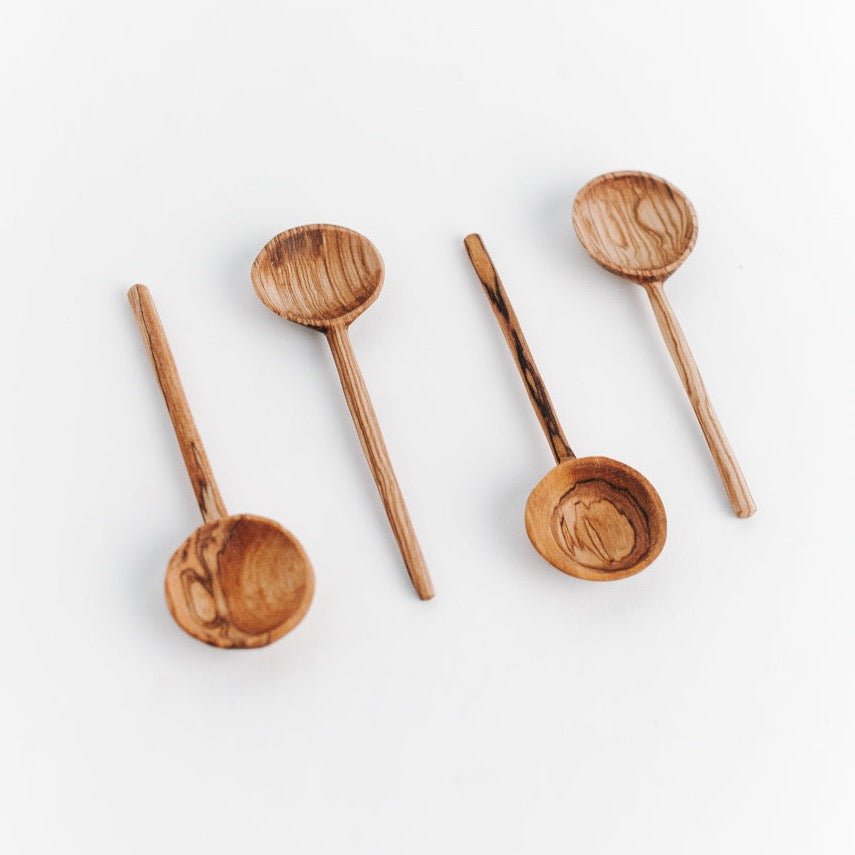 Petite spoons made of olive wood. The Olive Wood Coffee Spoon is designed by Creative Women and hand carved in Kenya.