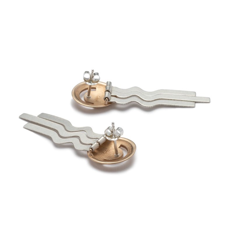 Lightweight, bronze, domed studs with wavy sterling silver fringe, sterling silver earring posts, and sterling silver ear nuts. Hand-crafted in Portland, Oregon.