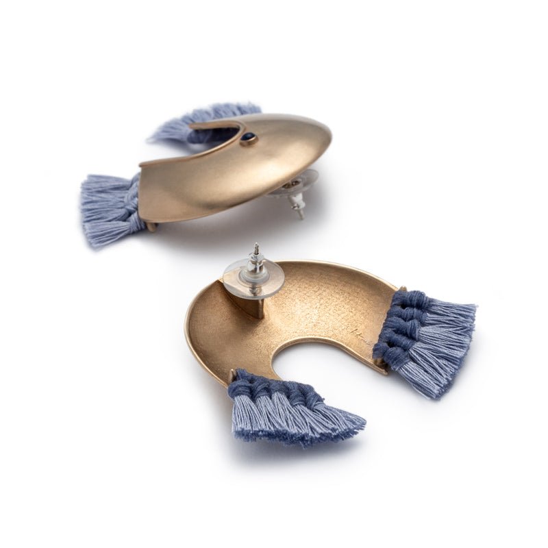 Oversized, arc-shaped bronze earrings with light blue cotton fringe, ethically sourced and fair trade lapis lazuli, sterling silver earring posts, and sterling silver and plastic comfort-clutch backings. Hand-crafted in Portland, Oregon.