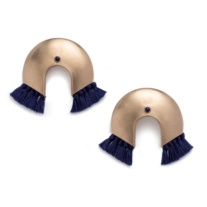 Oversized, arc-shaped bronze earrings with navy cotton fringe and ethically sourced, fair trade lapis lazuli. Hand-crafted in Portland, Oregon.
