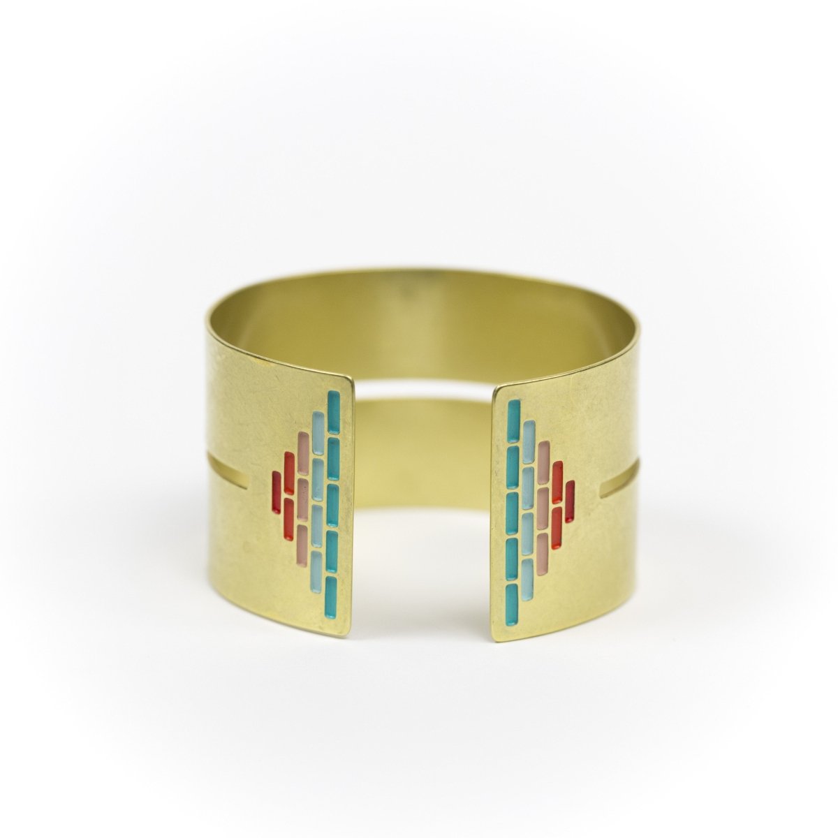 Wide, bold, brass cuff bracelet in the Mexico colorway, with a cutout slit that runs through the center of the cuff and stops just short of a pyramid of rich teal and red paint on either end. Hand-crafted in Portland, Oregon.