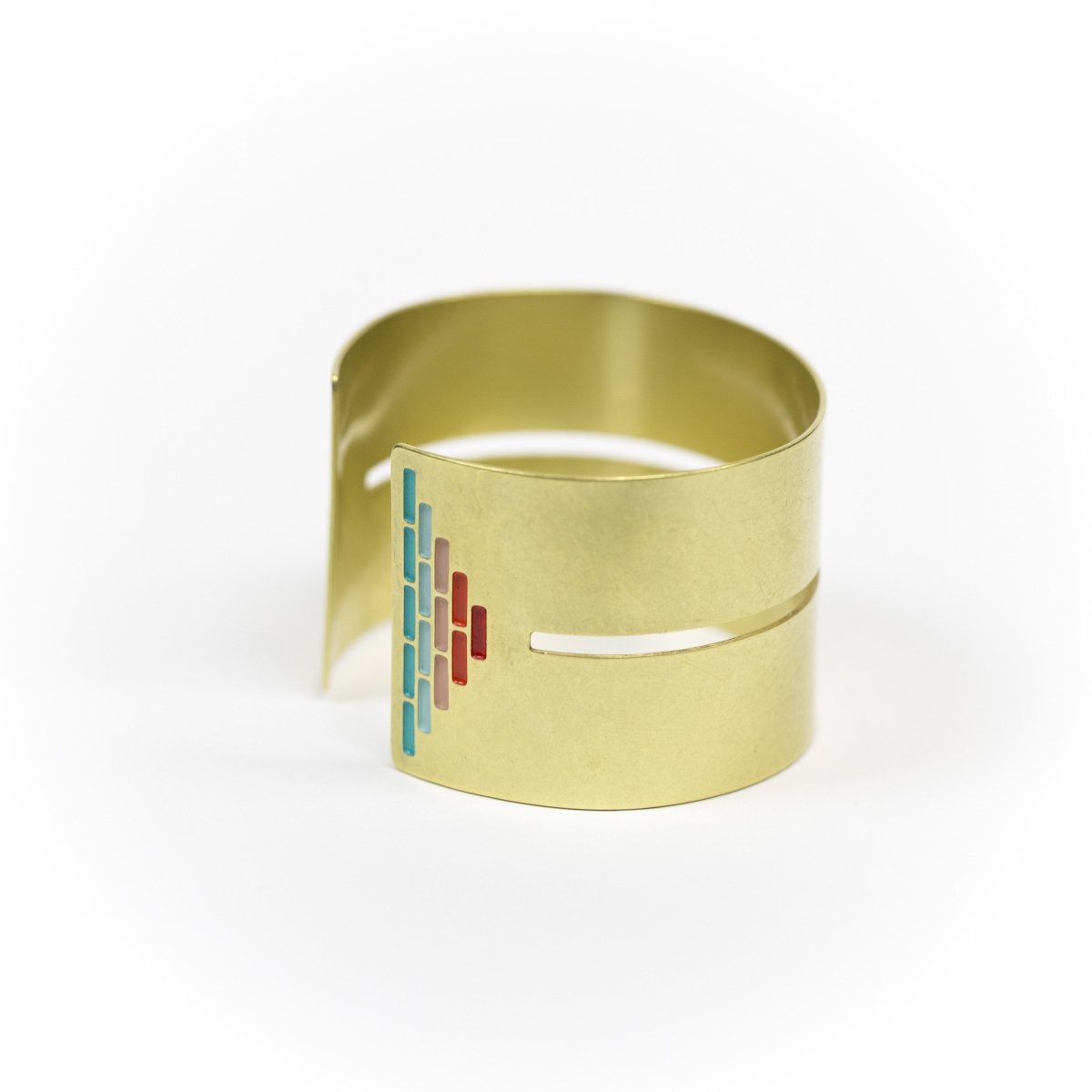 Wide, bold, brass cuff bracelet in the Mexico colorway, with a cutout slit that runs through the center of the cuff and stops just short of a pyramid of rich teal and red paint on either end. Hand-crafted in Portland, Oregon. 