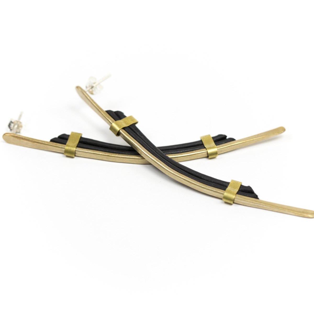 Long gold bar earring with silver posts and black leather.