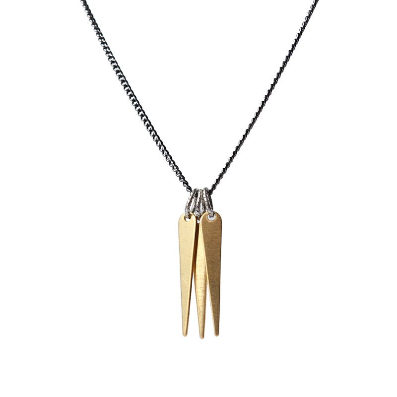 A trio of decorative brass spikes, dangling from a gunmetal and steel chain, and finished with a hand-formed, sterling silver clasp and closure. Hand-crafted in Portland, Oregon.