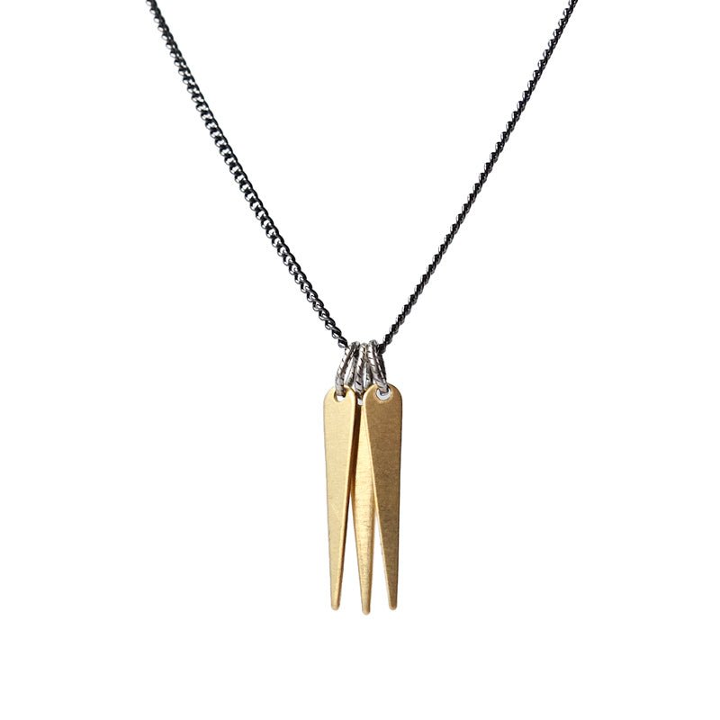 A trio of decorative brass spikes, dangling from a gunmetal and steel chain, and finished with a hand-formed, sterling silver clasp and closure. Hand-crafted in Portland, Oregon. 