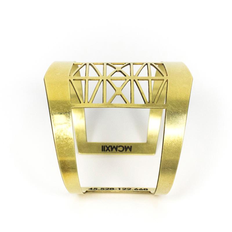 Modern, bold, and adjustable brass cuff bracelet modeled after the Steel Bridge in Portland, Oregon, with the bridge's coordinates and date of construction engraved on the inner cuff. Hand-crafted in Portland, Oregon.