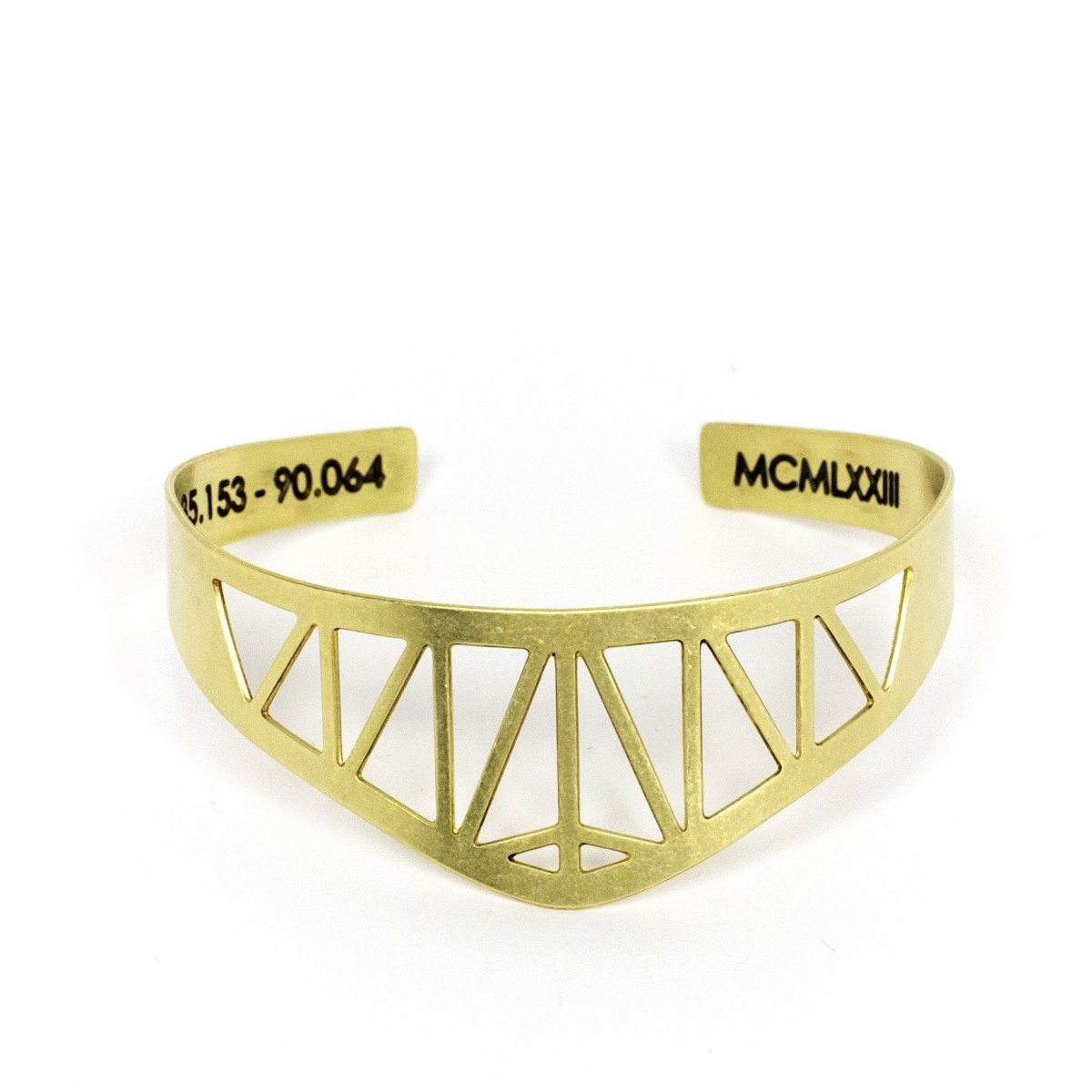 Modern, delicate, and adjustable brass cuff bracelet modeled after the Hernando de Soto Bridge in Memphis, Tennessee, with the bridge's georgraphical coordinates and date of construction engraved on the inner cuff. Hand-crafted in Portland, Oregon.
