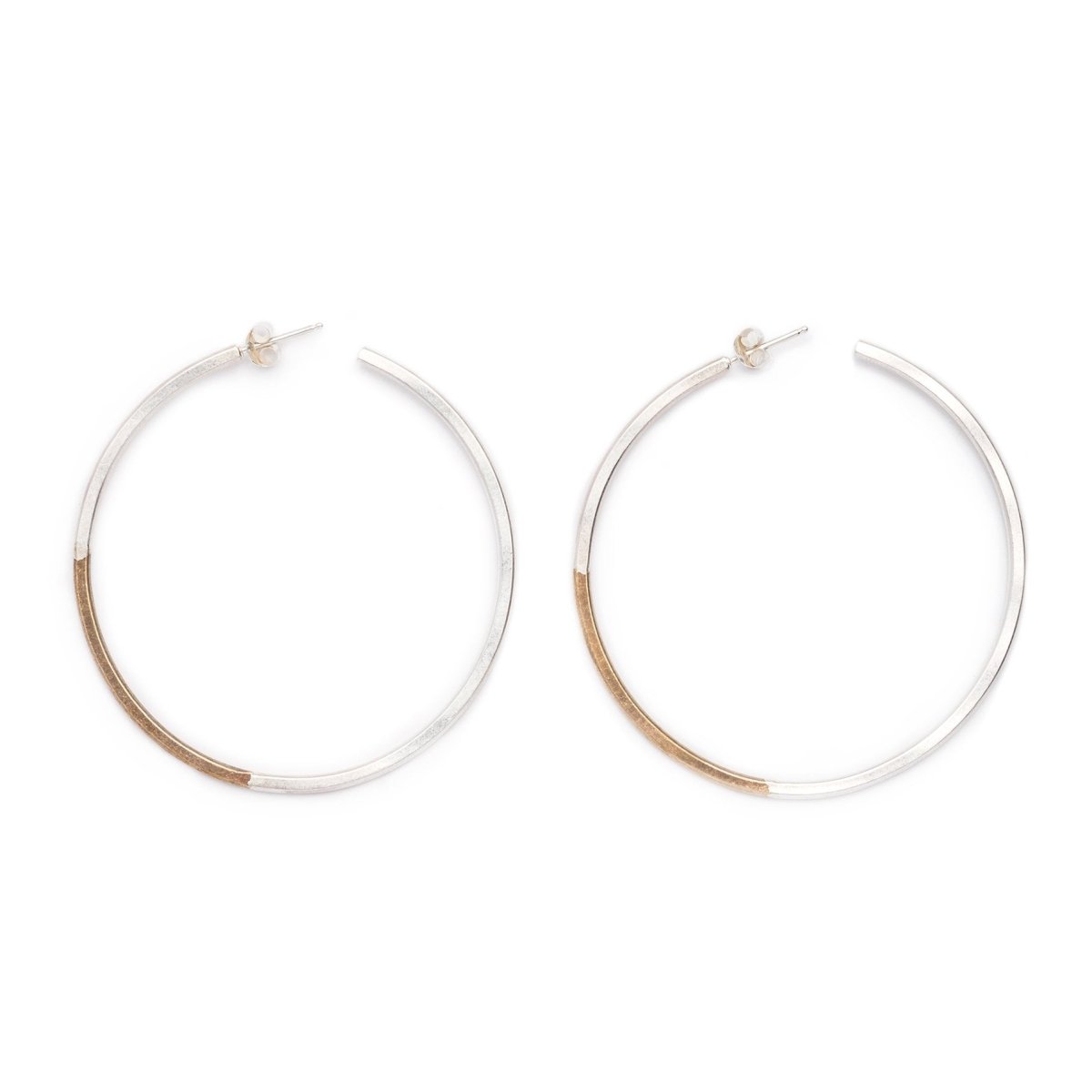 Classic, large, lightweight hoop earrings of mixed brass and sterling silver hand-forged wire, with sterling silver earring posts and sterling silver butterfly backings. Hand-crafted in Portland, Oregon.