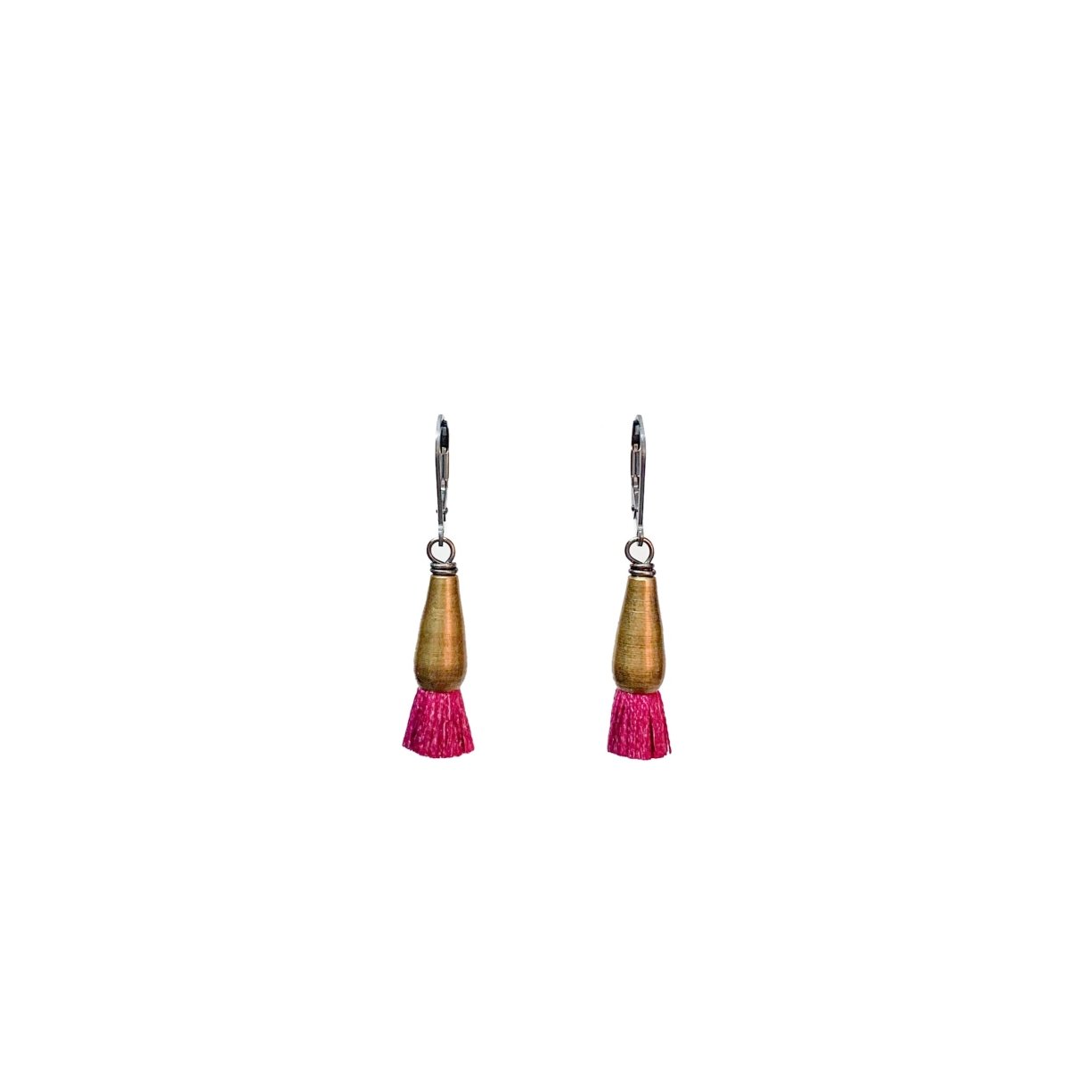A pair of brass earrings finished with hot pink silk tassels. The Bud Earrings in Fuchsia are from designer Emily Bixler of BOET.