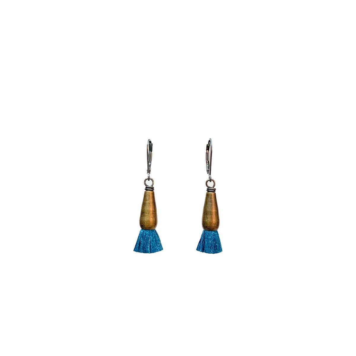 A pair of brass earrings finished with blue silk tassels. The Bud Earrings in Peacock are from designer Emily Bixler of BOET.
